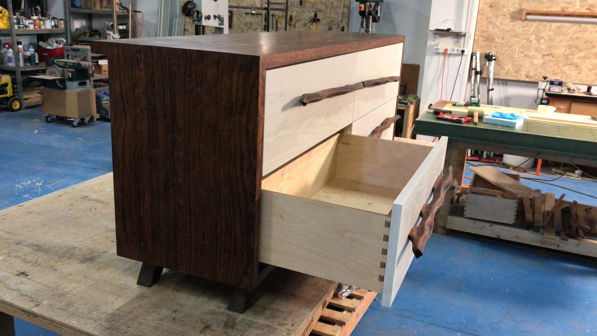 A finished credenza, drawer open, in the AR78 workshop